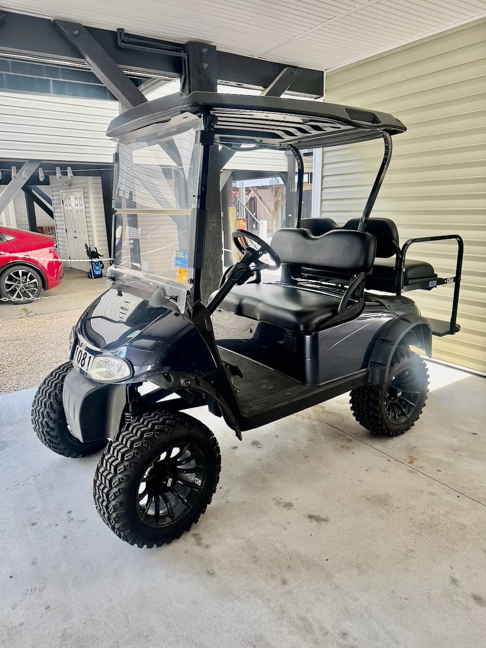 Ocean Echoes 4-person golf cart under the carport